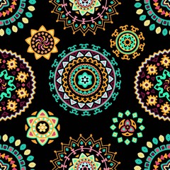 Seamless pattern of bright colorful geometric round ethnic decorative elements. Vector mandala background with bohemian, Oriental, Indian, Arabic, Aztec motifs.