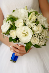Bride holds a wedding bouquet in her hands