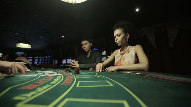 Players in casino, play in blackjack card game