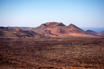 Fototapeta na wymiar Volcanic landscape in Tmanfaya national park on Lanzarote island in Spain