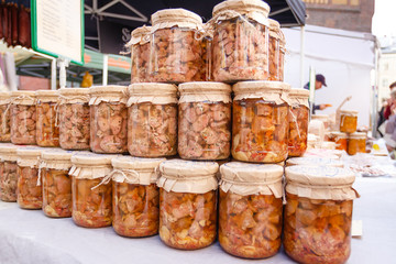 Canned homemade meat in a glass jar on market