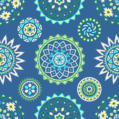 Seamless pattern of bright colorful geometric round ethnic decorative elements. Vector mandala background with bohemian, Oriental, Indian, Arabic, Aztec motifs.