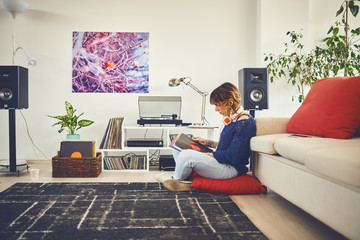 Woman listening vinyl at home
