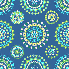 Seamless pattern of bright colorful geometric round ethnic decorative elements. Vector mandala background with bohemian, Oriental, Indian, Arabic, Aztec motifs.