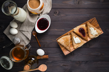 Fototapeta na wymiar ingredients for baking pancakes on a wooden background