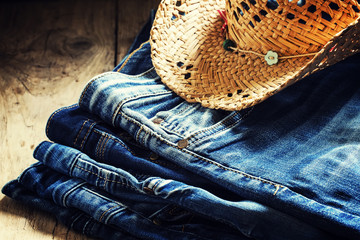 Jeans, straw hat, leather belt - women's clothes in cowboy count
