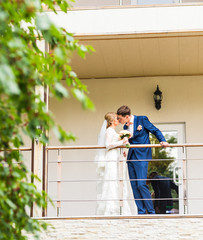 the bride and groom on a balcony