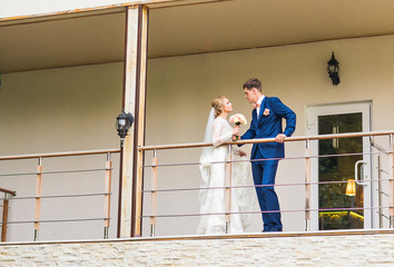 the bride and groom on a balcony