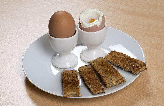 Breakfast of boiled eggs and soldiers on a plate