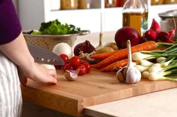 Cook's hands preparing vegetable salad - closeup shot