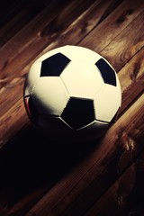 Soccer ball on wooden boards.