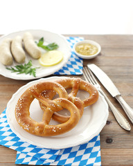 Pretzels with  white sausages on background