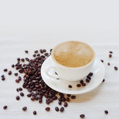 Coffee cup and beans, white background. still life on table cloths