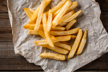 French fries on wooden table.