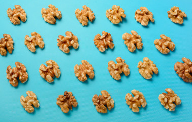 Walnuts in pattern on turquoise-blue background 