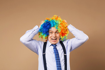 screaming businessman with large colorful wig.