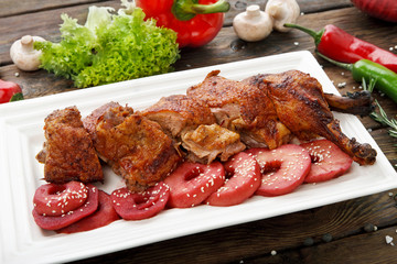 Roasted duck with apples and vegetables.