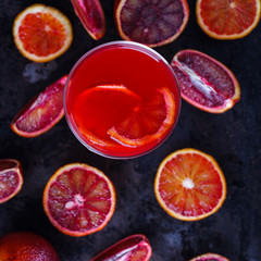 Glass of freshly squeezed orange juice,blood orange,on a black background.selective focus.