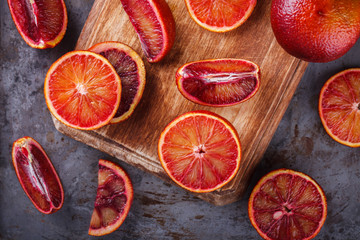 blood orange on a wooden Board,cut into wedges.selective focus.