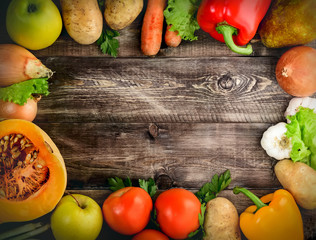 Vegetables and fruits on a wooden background