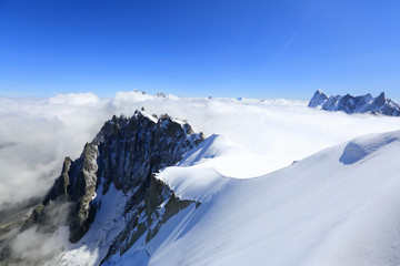 Fototapeta na wymiar Mont Blanc mountain peak above low clouds