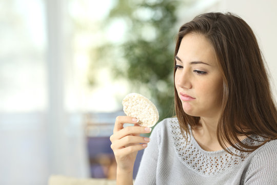 Girl disgusted looking a dietetic cookie