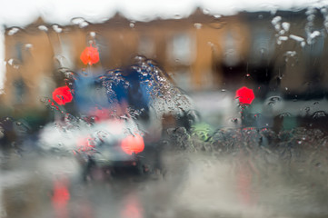 Traffic through a car windscreen during heavy rain.