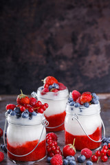 Yogurt,homemade,with fresh berries, berry puree in a glass container.Healthy eating.selective focus.