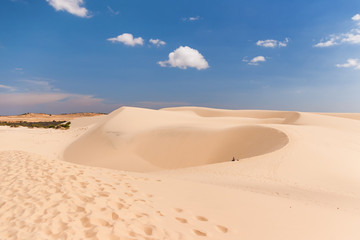 Alone man in desert. The White Dunes (bau sen, bau trang). Mui Ne, Vietnam.