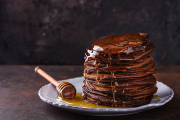 Chocolate pancake with honey.selective focus