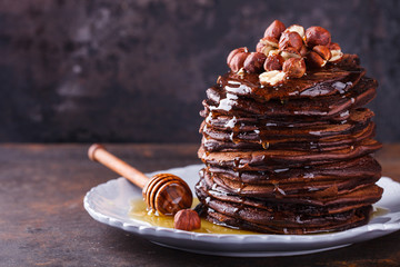 Chocolate pancake with honey and hazelnuts.selective focus - obrazy, fototapety, plakaty