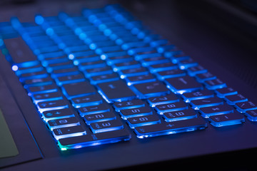 close-up of notebook keyboard with blue light tint