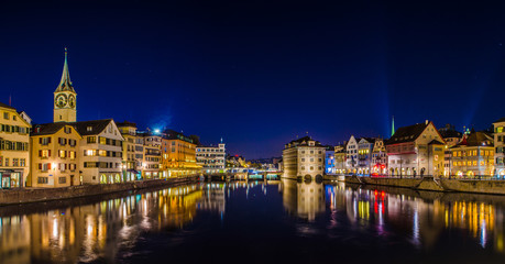 Night view of zurich from the munsterbrucke with building of the town hall on right side and saint...