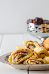 Klecha Iraqi Date Cookies with Dates in the Background with Copy Space Vertical