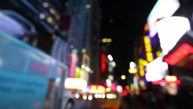 City lights and cars driving in traffic background, Times Square. Out of focus background with blurry unfocused city lights and driving cars and car light. Times Square, Manhattan, New York City.