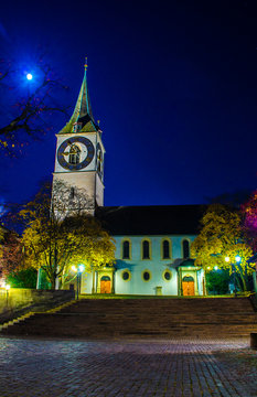 View of the church of saint peter in swiss city zurich during night