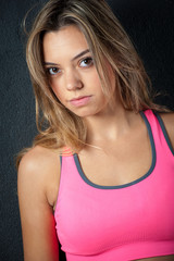 Attractive female fitness model isolated on a black background