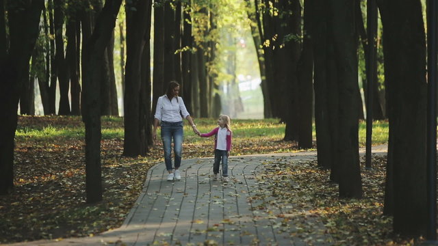 Family values: Mother and child walking in autumn park