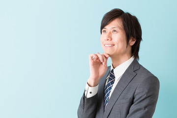 portrait of asian businessman on blue background