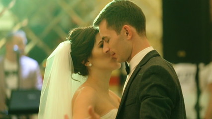 First wedding dance of a young beautiful  married couple in love in a fancy restaurant.