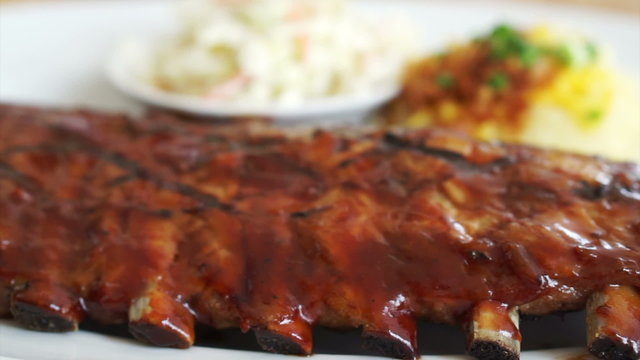 Video baby pork ribs spare with barbecue sauce, mashed potatoes and coleslaw