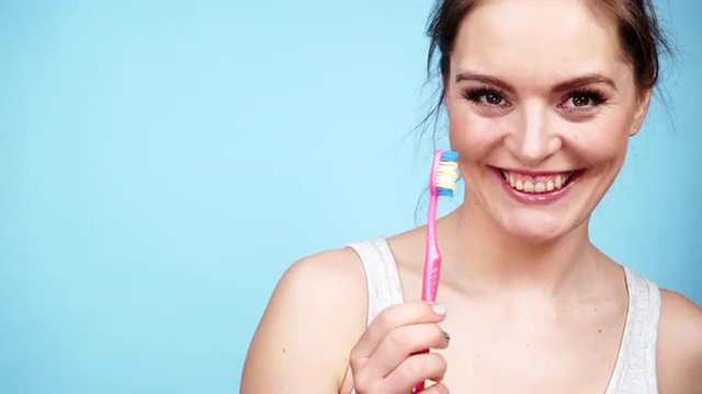 Woman holds toothbrush, teeth cleaning 4K
