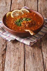 Thick Moroccan soup in a bowl on the table. vertical
