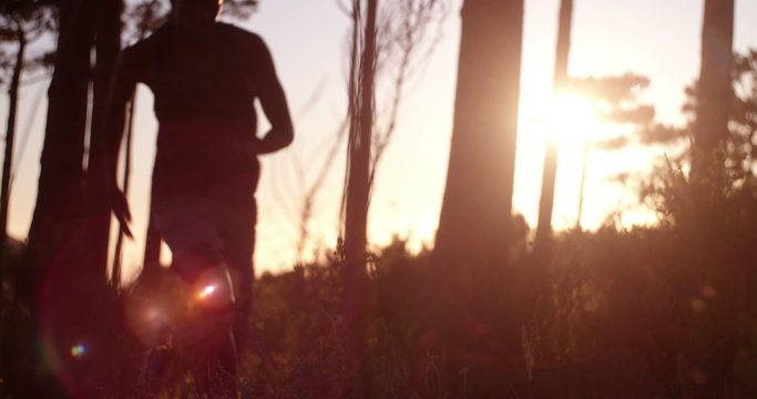 Cropped sun flare shot afro-american athlete sprinting past