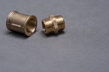 Brass plumbing fittings on grey table