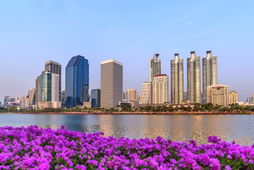 Bangkok skyline and water reflection with urban lake in summer.
