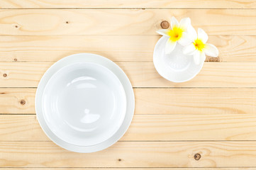 Blank bowl on dish and little bowl with flower , on wood background.
