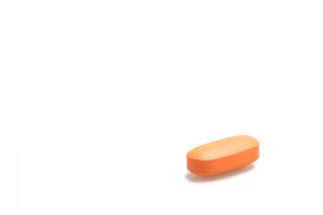 Orange pills on white background