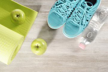 yoga mat with sport shoes and green apple healthy lifestyle concept