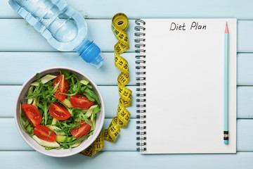 Diet plan, menu or program, tape measure, water and diet food of fresh salad on blue background, weight loss and detox concept, top view - obrazy, fototapety, plakaty